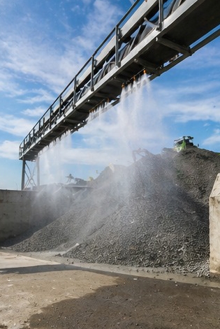 Dust suppression with water sprinklers over aggregate stockpiles